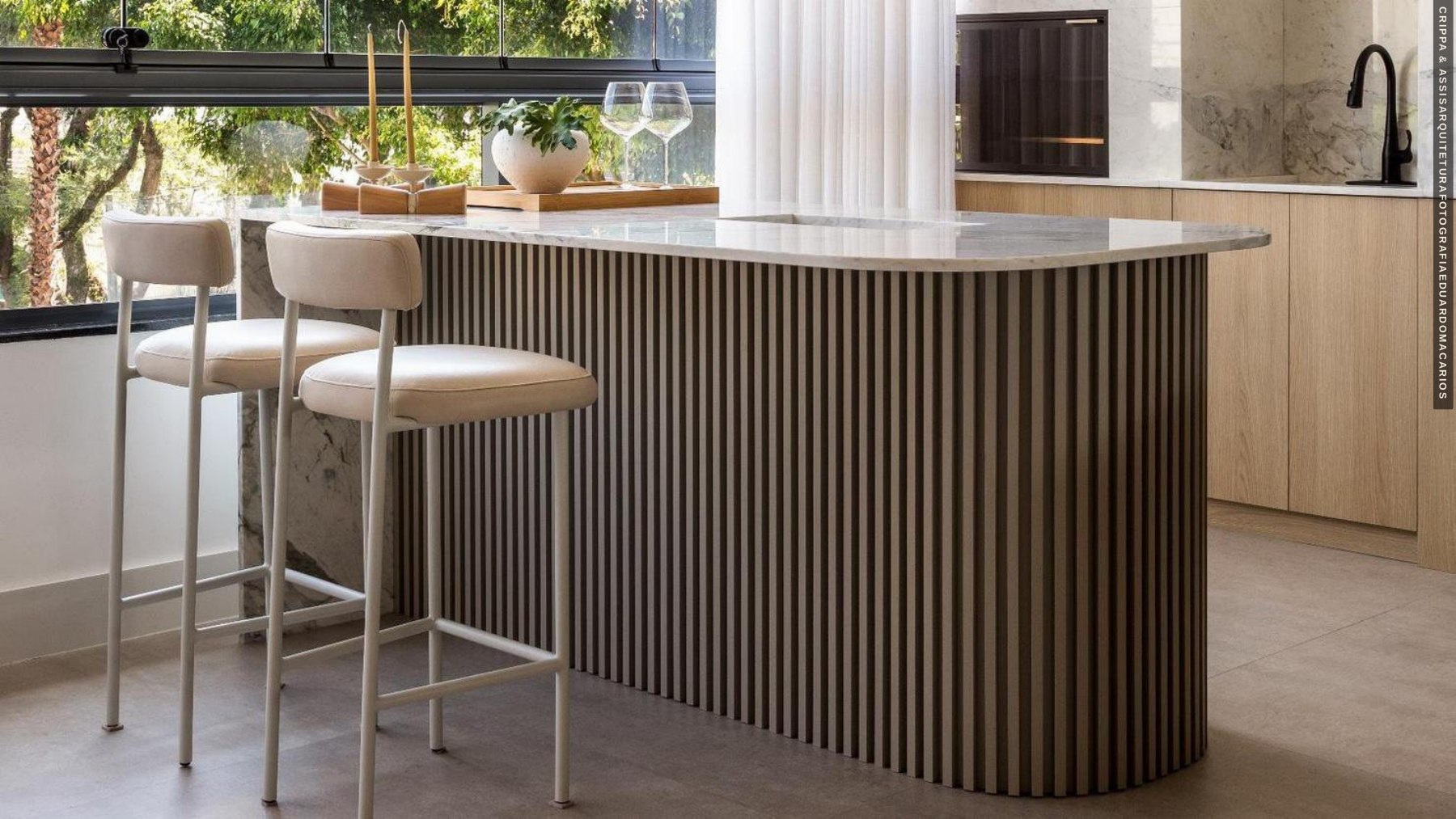 Curved kitchen island with vertical wood detailing