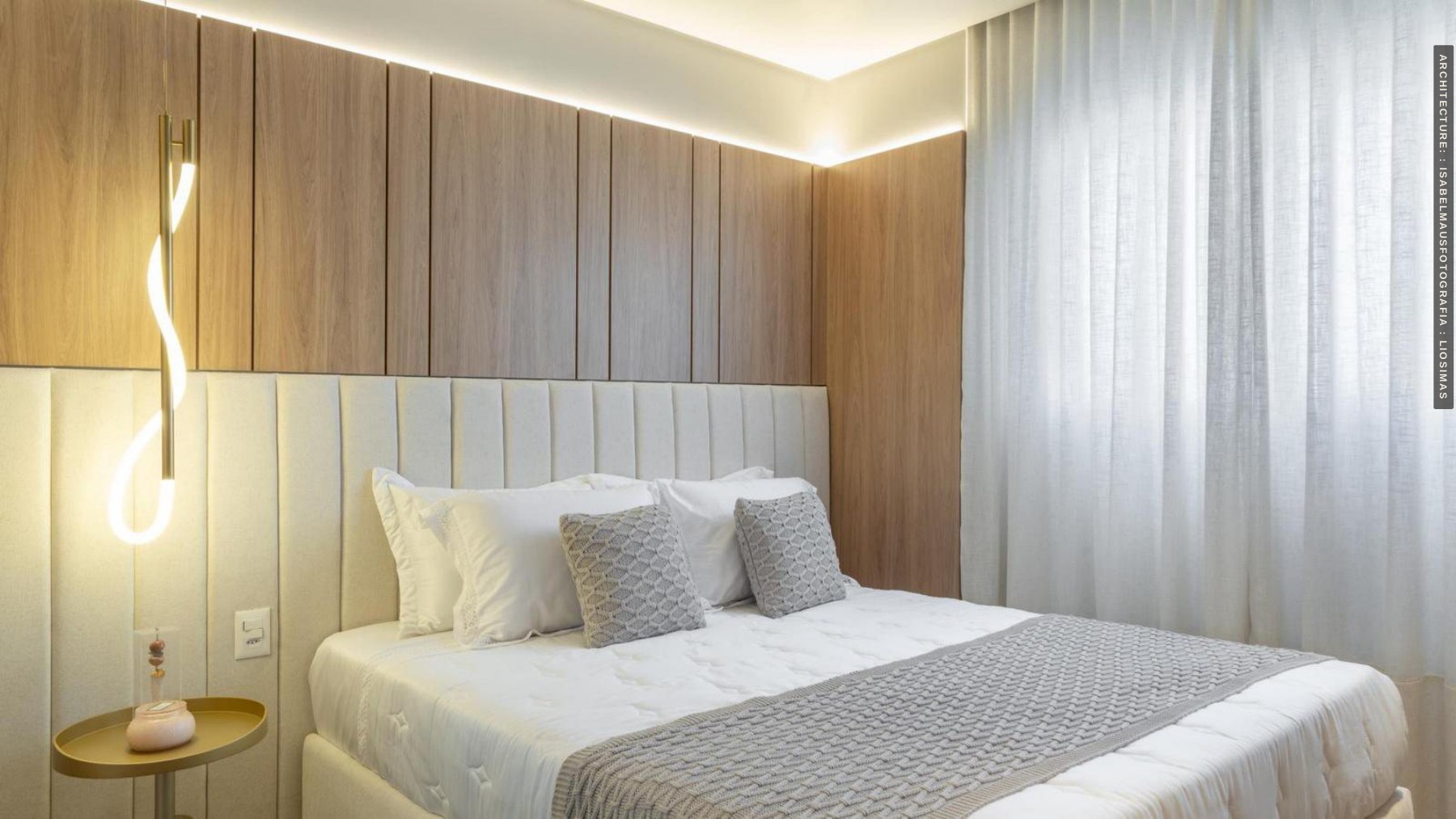 Bedroom with a wood headboard and integrated side furniture