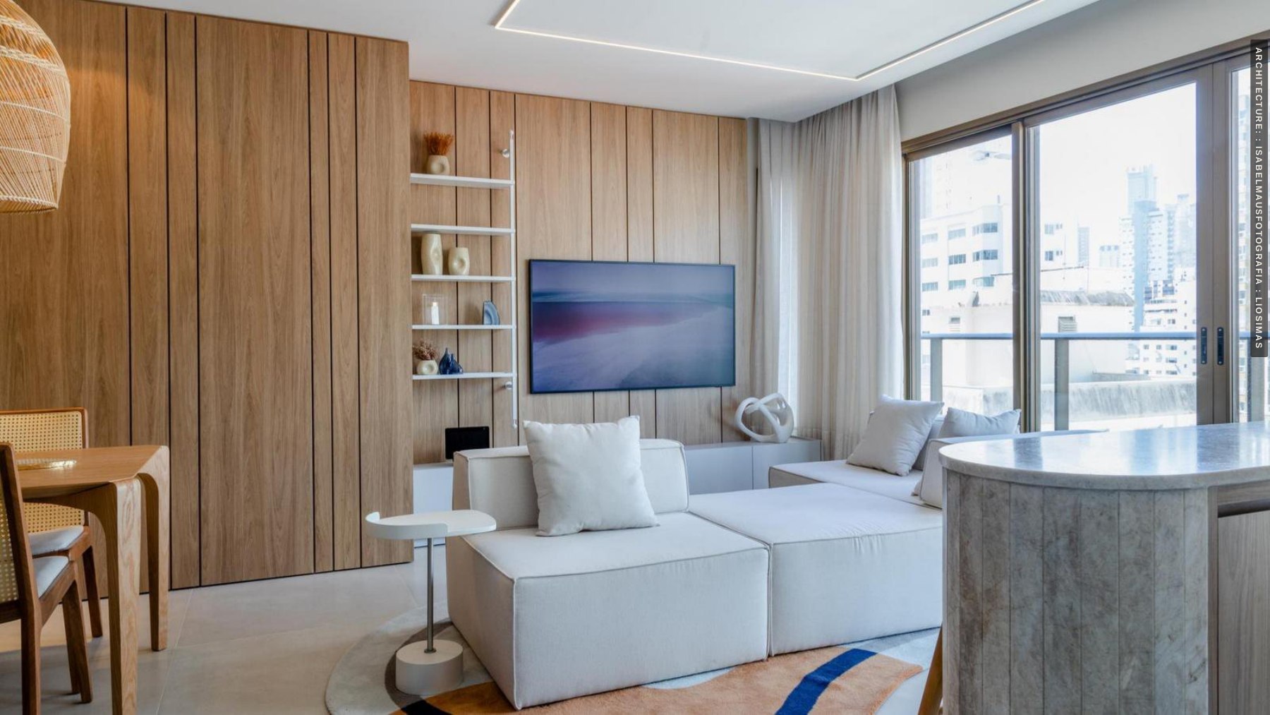 Living room with wood cabinetry and an integrated media wall